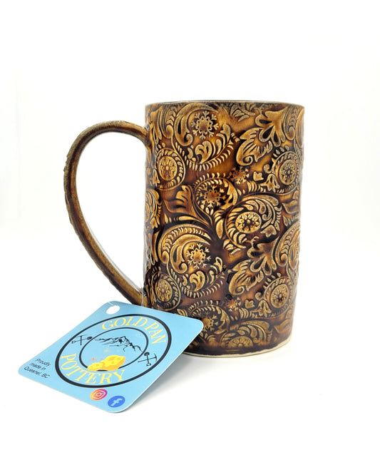 Handmade pottery mug, ornate pattern, brown