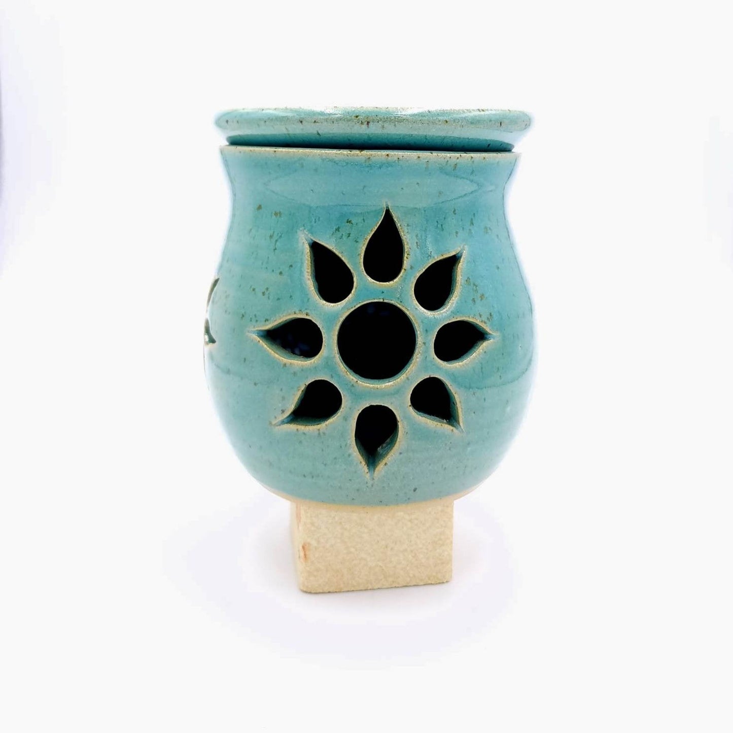 Handmade pottery wax melter. This piece has been hand carved with 3 sun burst and then glazed in a beautiful teal glaze. 10.5cm x 9.5cm